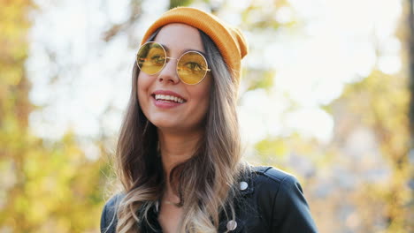 Close-up-view-of-a-young-Caucasian-woman-wearing-sunglasses-and-beanie-looking-aside