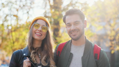 Young-Caucasian-woman-wearing-glasses-and-beanie-and-caucasian-man-looking-aside