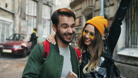 Close-up-view-of-young-Caucasian-couple-of-friends-walking-down-the-street