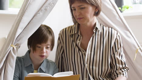 Teenager-reading-book-with-the-help-of-her-mother