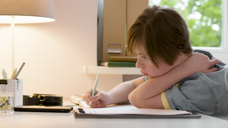 Young-girl-studying-and-writing-on-paper