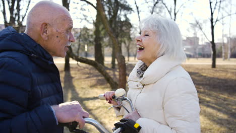 Close-up-view-of-a-senior-couple-talking-and-laughing-in-the-park-on-a-winter-day