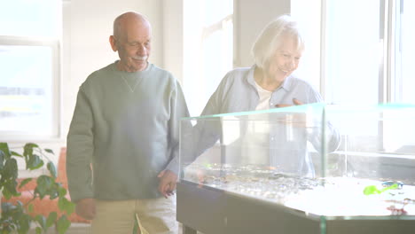 Senior-couple-holding-hands-and-looking-at-jewelry-inside-an-urn-in-a-studio