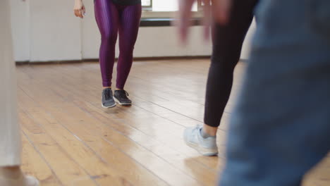 Primer-Plano-De-Las-Piernas-De-Los-Bailarines-Aprendiendo-Paso-De-Baile-En-El-Estudio