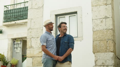 Front-view-of-happy-homosexual-male-couple-hugging-outside