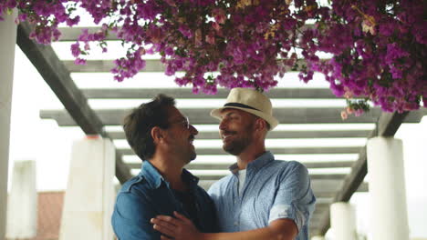 Front-view-of-gay-couple-hugging-and-kissing-in-gazebo