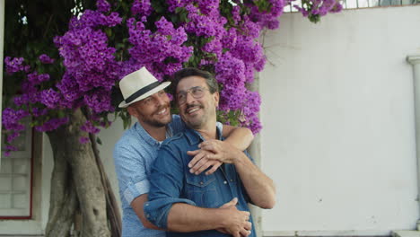 Hombre-Homosexual-Feliz-Con-Sombrero-Abrazando-A-Su-Novio-Desde-Atrás