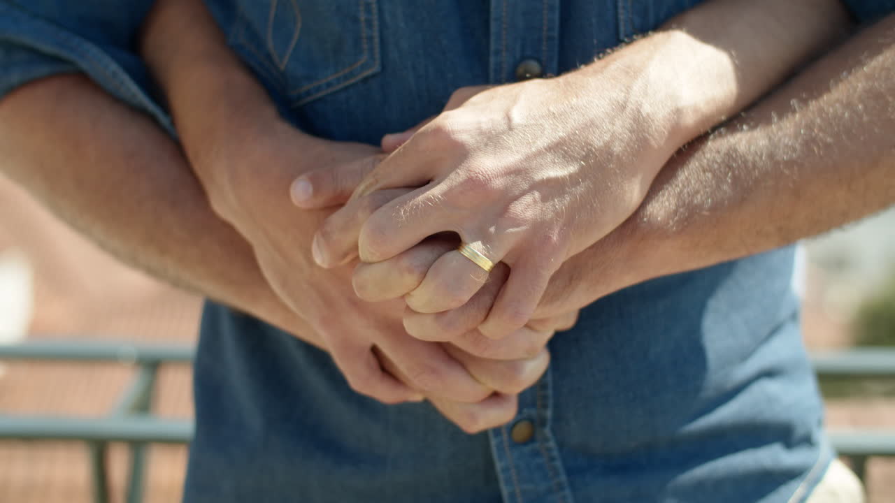 Free stock video Closeup shot of gays hands with engagement ring on