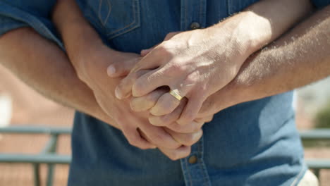 Close-up-shot-of-gays-hands-with-engagement-ring-on-finger