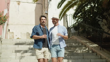 Long-shot-of-smiling-homosexual-men-going-down-stairs-in-street