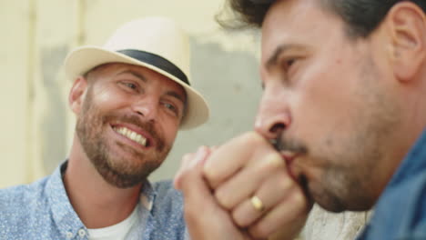 Close-up-shot-of-bearded-gay-kissing-hand-of-his-lover