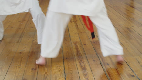 Close-up-shot-of-karatekas-legs-fighting-in-gym