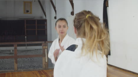 Handheld-shot-of-girls-bowing-before-starting-karate-training