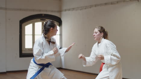 Tracking-shot-of-focused-girls-having-karate-class-in-gym