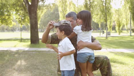 Happy-family-meeting-father-from-military-mission-at-the-park