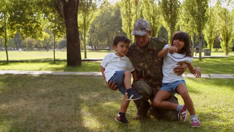 Happy-military-father-wearing-uniform,-playing-and-posing-with-his-kids