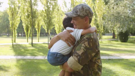 Excited-kid-running-to-military-dad's-open-arms