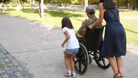 Disabled-retired-ex-soldier-in-camouflage-walking-with-family-at-the-park