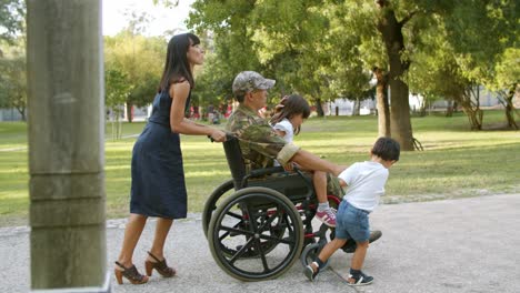 Disabled-ex-military-man-walking-with-kids-and-wife
