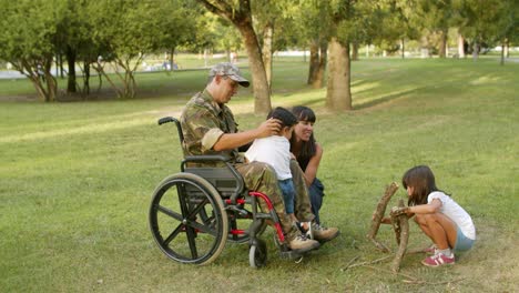 Happy-kids-enjoying-leisure-time-with-handicapped-military-dad-and-mom