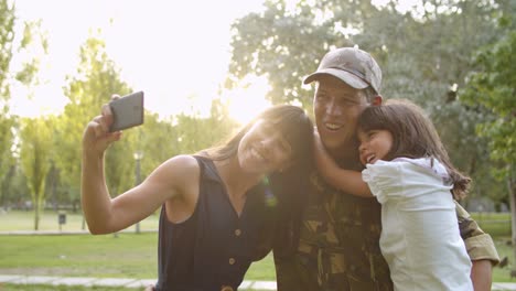 Happy-military-couple-of-parents-and-cute-child-taking-selfie