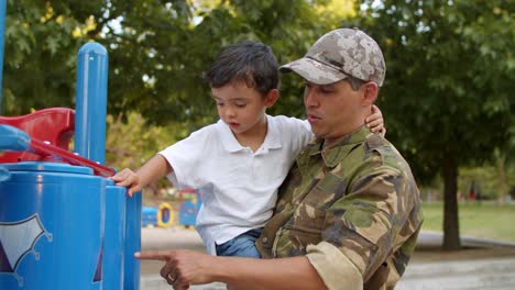 Military-dad-spending-leisure-time-with-little-son-in-park