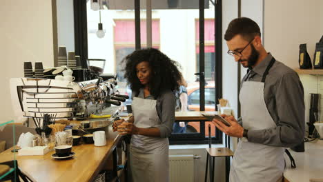 African-american-female-barista-and-caucasian-male-coworker-working-in-modern-coffee-shop