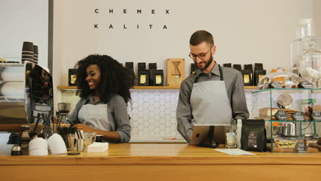 African-american-female-barista-and-caucasian-male-coworker-working-in-modern-coffee-shop