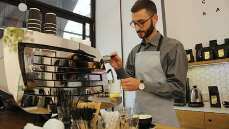 Caucasian-male-barista-working-in-modern-coffee-shop