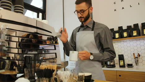 Caucasian-male-barista-working-in-modern-coffee-shop
