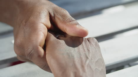 Close-up-of-homosexual-men-touching-each-other-hands-with-care