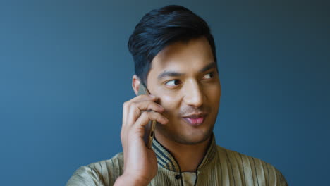 Close-up-view-of-indian-young-man-in-traditional-clothes-talking-on-the-phone