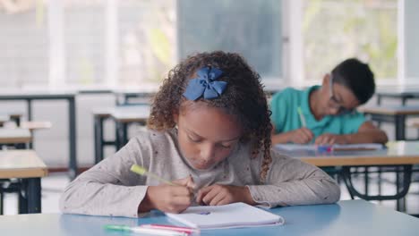 Focused-Black-pupil-girl-using-pen-to-write-the-exercises