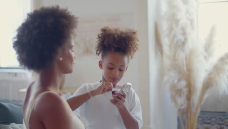 Cute-Black-girl-doing-make-up-on-her-mother