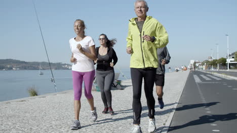 Active-senior-joggers-running-on-promenade