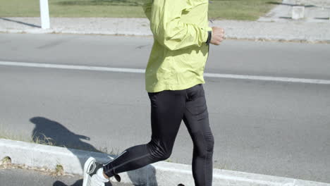 Active-senior-jogger-with-hearing-aid-device-running-outside