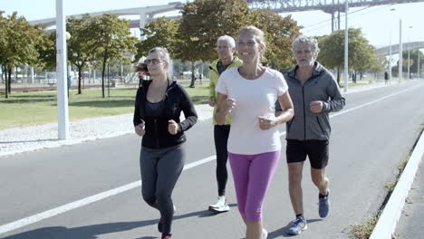 Active-elder-joggers-running-down-street
