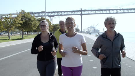Active-older-joggers-running-on-promenade