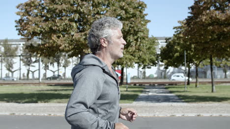 Senior-male-runner-jogging-outside