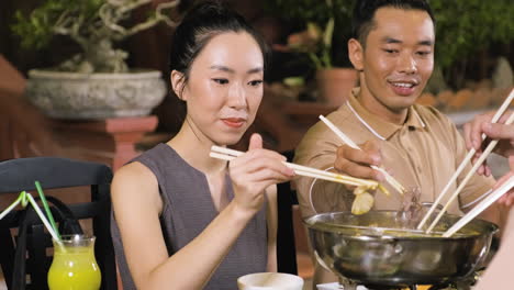 Young-people-enjoying-yummy-chinese-food