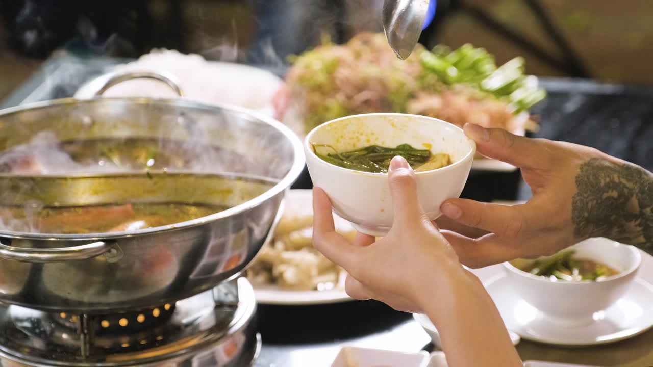 Free stock video - Unrecognizable person filling bowl with chinese soup