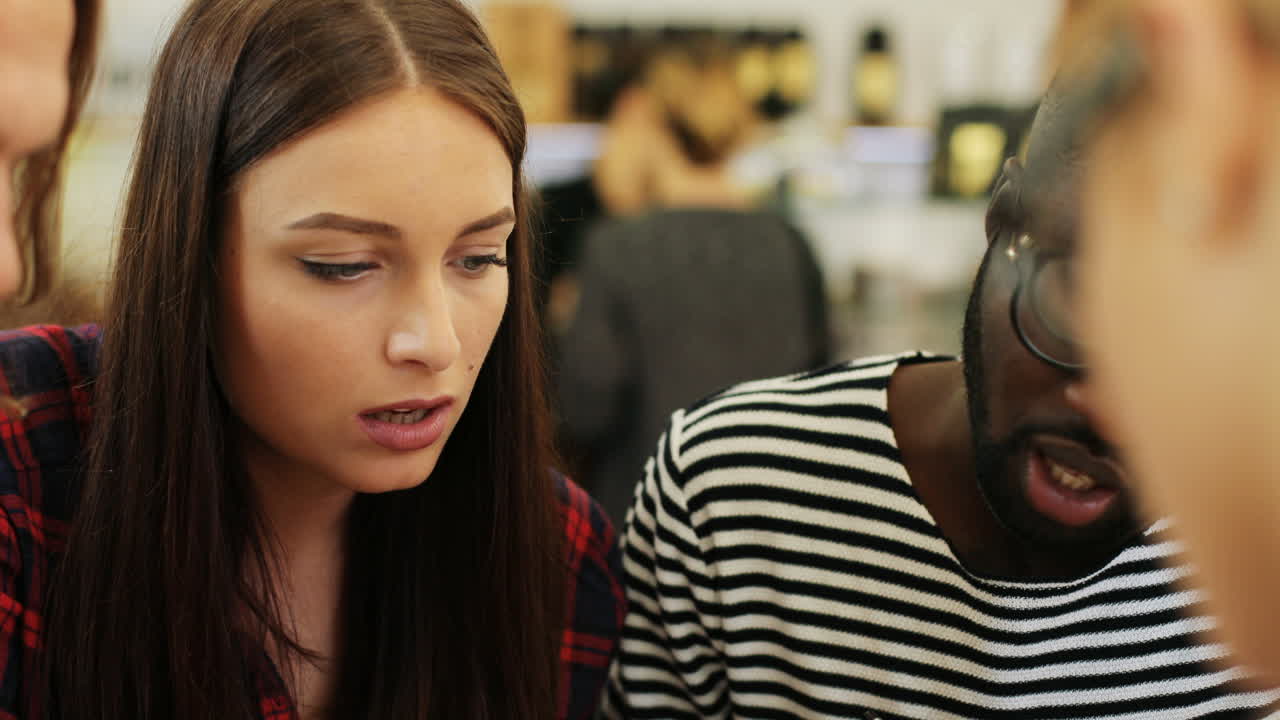 Free stock video - Close-up view of multiethnic coworkers reading