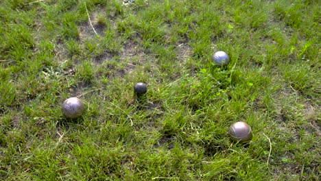 Top-view-of-pentanque-balls-on-the-grass-in-the-park