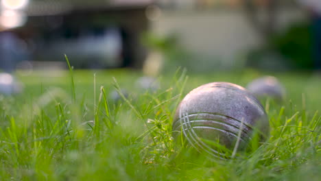 Close-up-view-of-a-metal-petanque-ball-on-the-grass