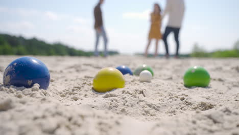 Close-up-view-of-some-colorful-petanque-balls-on-the-beach-on-a-sunny-day