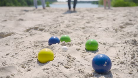 Close-up-view-of-some-colorful-petanque-balls-on-the-beach-on-a-sunny-day