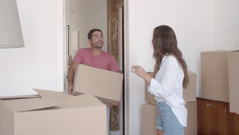 Happy-couple-opening-door-and-coming-into-new-apartment