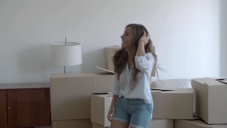 Happy-woman-dancing-in-new-apartment