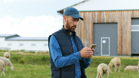 Caucasian-farmer-man-texing-message-on-smartphone-outside