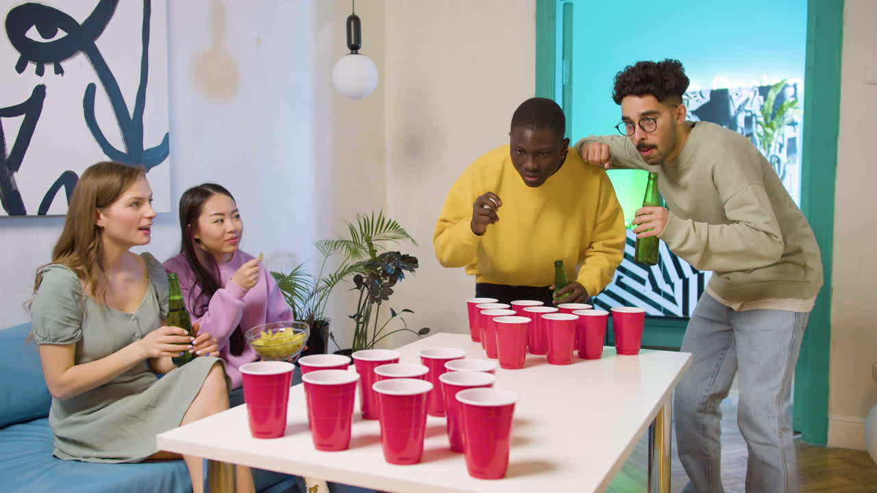 Free stock video - Happy multiethnic young friends playing beer pong at ...